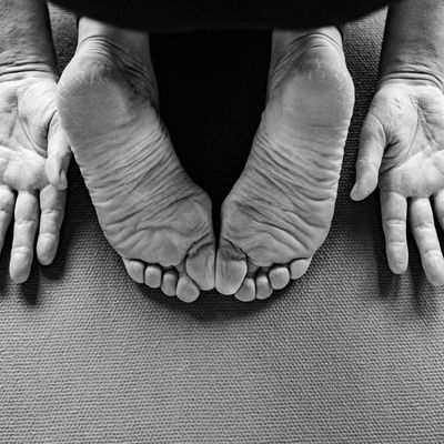 Close-up on strong, stable hands during a yoga practice on a mat.